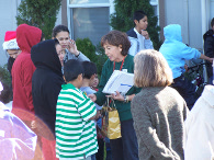 A family receiving a grocery gift certificate