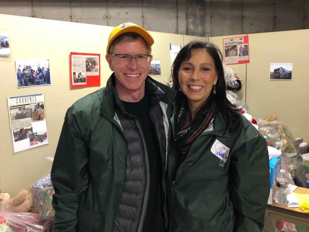 Two volunteers smiling at the gift warehouse